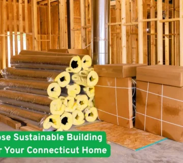 Construction site interior with wooden framing, stacked insulation rolls and boxed duct materials for a green build projects
