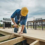 Man working deck with black grill